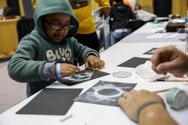 DJ Darrius Yancy, 4, creates his own eclipse craft at The Science Center table during the Crossroads Astronomy, Science and Technology Expo at Southern Illinois University in Carbondale on April 7, 2024. (Eileen T. Meslar/Chicago Tribune)