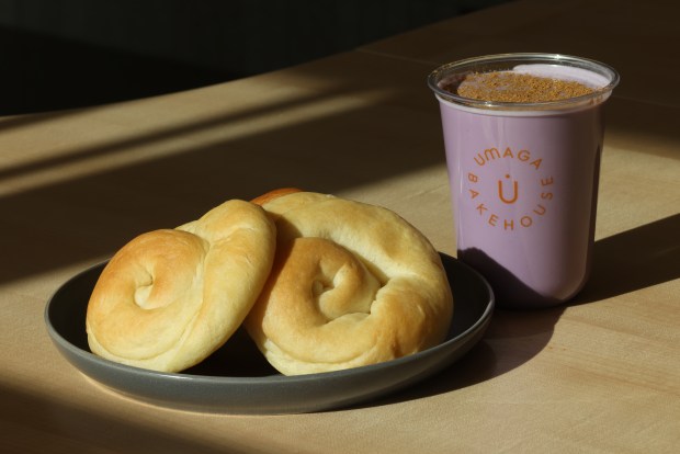 An ensaymada along side an ube horchata drink, at Umaga Bakehouse, a new modern Filipino bakery, in Chicago, on April 25, 2024. (Antonio Perez/Chicago Tribune)Ube horchata, and bread is sumply ensaymada