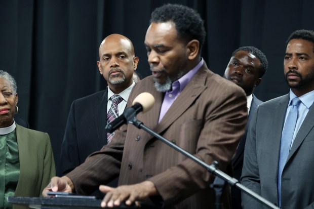 Cook County State's Attorney candidate Clayton Harris III, center left, attends a press conference at Quinn Chapel AME Church in Chicago on March 14, 2024, where he and area faith leaders, including Ira Acree, foreground, demanded that State's Attorney candidate Eileen Burke return the $5,000 campaign contribution she took from former Chicago Corporation Counsel Stephen Patton. (Terrence Antonio James/Chicago Tribune)