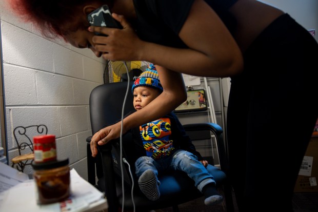 Joziah McAllister, 1, sits while his mother, Irmony Sneed, speaks on the phone, on March 5, 2024, at the Blanche Foxworthy Infant Care Center. (Vincent Alban/Chicago Tribune)