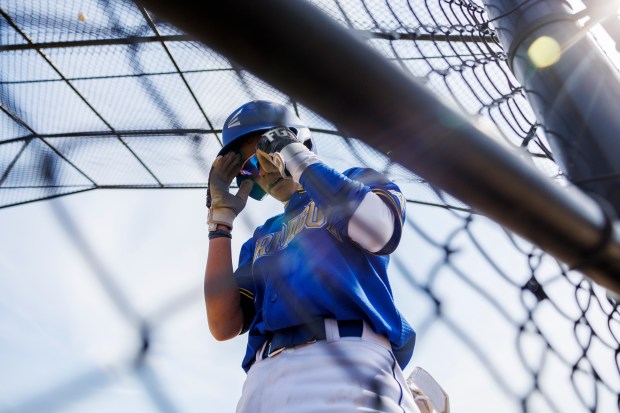 Farragut Career Academy sophomore Yoel Guerra, 16, from Venezuela adjusts his glasses after scoring a run during a game against Mather High School in La Villita Park on Friday, March 29, 2024, in Chicago. (Armando L. Sanchez/Chicago Tribune)