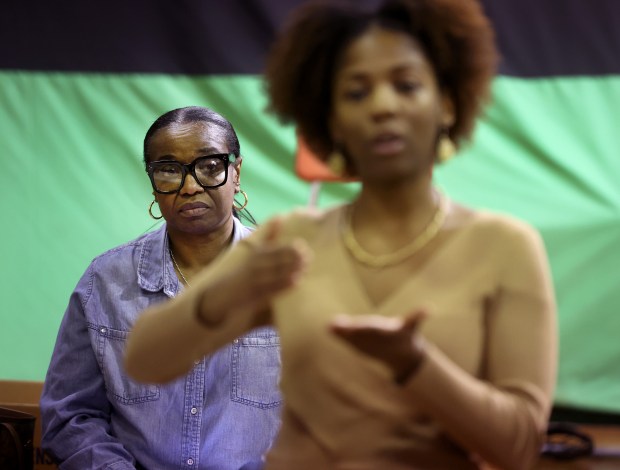 12th District Police Council board member Michelle Page, left, listens in as Briana Payton, at a monthly meeting of the 12th District Police Council on March 20, 2024. (Chris Sweda/Chicago Tribune)