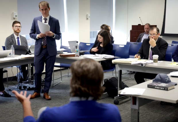 Attorney David Fox, standing, questions Dan Proft, seated, during a hearing held by the State Board of Elections after Illinois Democrats filed a complaint against Proft, a GOP strategist and right wing radio talk show host, for alleged illegal election coordination with former GOP gubernatorial nominee Darren Bailey, on April 29, 2024, in Chicago. (Stacey Wescott/Chicago Tribune)