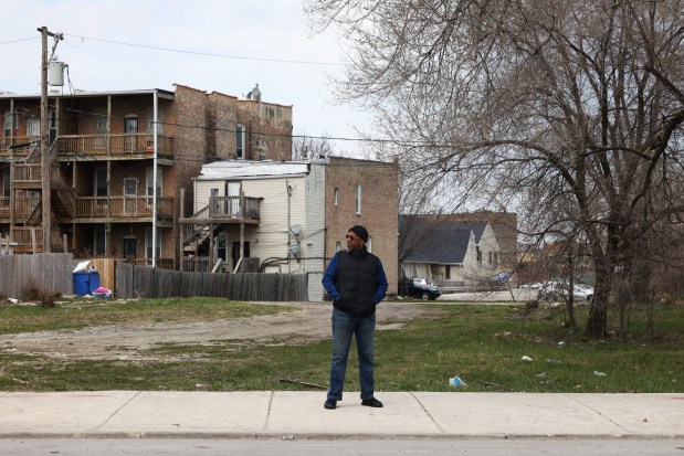 Brian K. Ellison stands in front of a vacant lot near his home on West Fifth Avenue in the East Garfield Park neighborhood, March 21, 2024, in Chicago. (John J. Kim/Chicago Tribune)