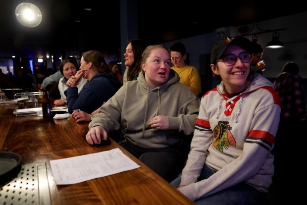 Meredith, center, and Michaela take in a televised women's NCAA Tournament Final Four game between South Carolina and North Carolina State at Whiskey Girl Tavern on North Clark Street in Chicago's Edgewater neighborhood on April 5, 2024. (Chris Sweda/Chicago Tribune)