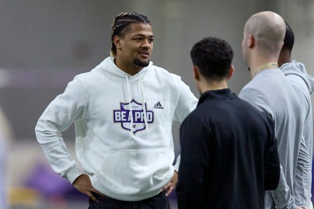 Washington wide receiver Rome Odunze talks while standing on the field during Washington's NFL Pro Day, Thursday, March 28, 2024, in Seattle. Odunze did not participate in the day. (AP Photo/John Froschauer)