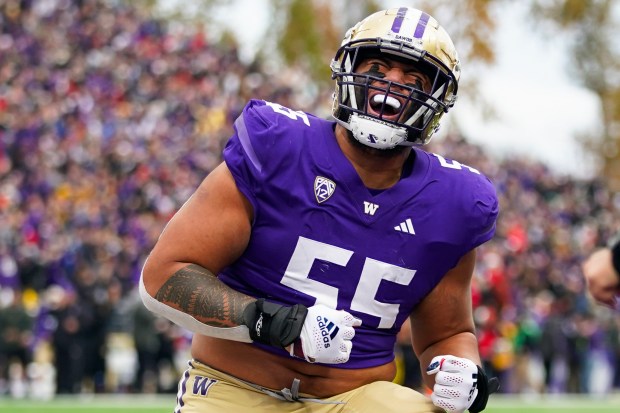 Washington offensive lineman Troy Fautanu reacts after a touchdown by running back Dillon Johnson against Utah on Nov. 11, 2023, in Seattle. (Lindsey Wasson/AP Photo)
