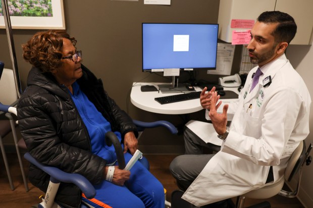 Dr. Gaurav Marwaha, interim chairperson in the Department of Radiation Oncology, checks in with cancer patient Louise Yates, left, at the Rush Rubschlager Building on April 25, 2024. (Eileen T. Meslar/Chicago Tribune)