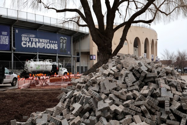 Trucks carrying out debris from the demolished Ryan Field have spread dust and dirt throughout the truck route in Evanston, neighbors say. Northwestern University announced it will distribute car wash vouchers for vehicles affected by the dust. (Antonio Perez/Chicago Tribune)