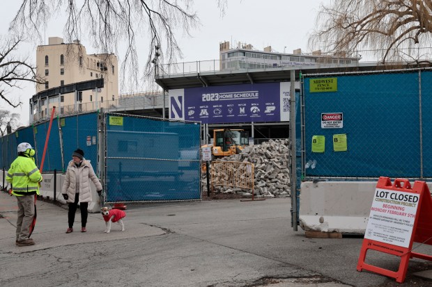 Sarah Hartigan talks with a worker as workers prepare for the start of the demolition of Northwestern University's Ryan Field in Evanston, Friday, Feb. 16, 2024, Dog's name was George, (Antonio Perez/ Chicago Tribune)