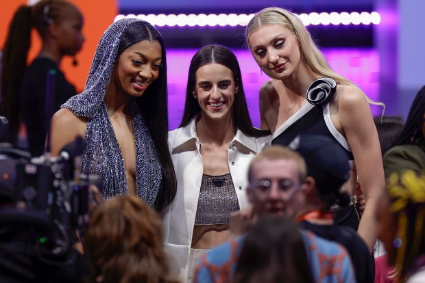 From left, LSU's Angel Reese, Iowa's Caitlin Clark and Stanford's Cameron Brink pose before the WNBA draft on Monday, April 15, 2024, in New York. (AP Photo/Adam Hunger)
