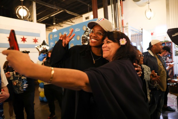 A fan poses with Chicago Sky player Diamond DeShields during Chicago Sky's WNBA draft watch party at Revolution Brewing in Chicago on April 15, 2024. (Eileen T. Meslar/Chicago Tribune)