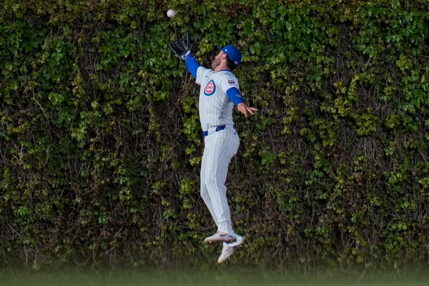 Cubs center fielder Cody Bellinger crashed into the wall while trying to catch a double from the Astros' Yainer Diaz in the fourth inning on April 23, 2024, at Wrigley Field. (Erin Hooley/AP)