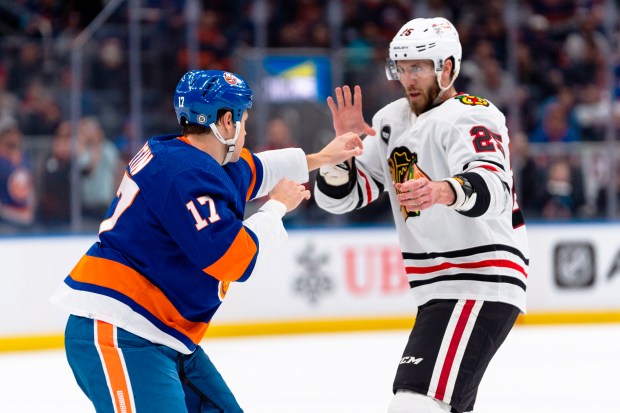 New York Islanders left wing Matt Martin (17) and Chicago Blackhawks defenseman Jarred Tinordi (25) fight during the first period of an NHL hockey game in Elmont, N.Y., Tuesday, April 2, 2024. (AP Photo/Peter K. Afriyie)