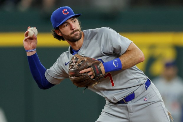 Chicago Cubs shortstop Dansby Swanson throws to first between innings during a baseball game against the Texas Rangers, Sunday, March 31, 2024, in Arlington, Texas. (AP Photo/Gareth Patterson)