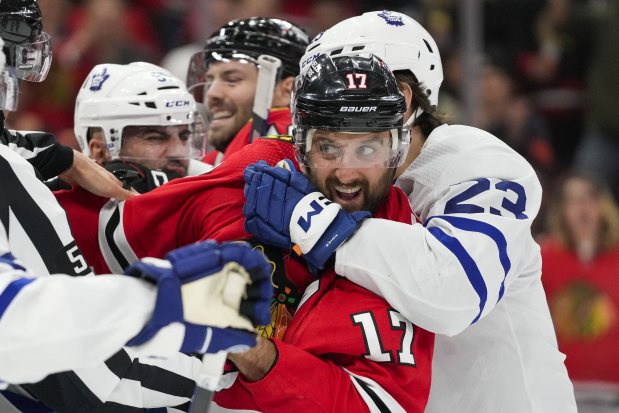 Chicago Blackhawks left wing Nick Foligno (17) fights with Toronto Maple Leafs players during the third period of an NHL hockey game Friday, Nov. 24, 2023, in Chicago. (AP Photo/Erin Hooley)