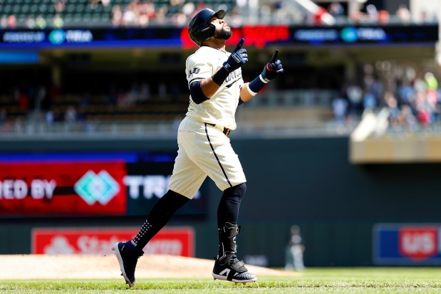 Twins first baseman Carlos Santana celebrates his solo home run in the eighth inning against the White Sox on April 25, 2024, in Minneapolis. The Twins won 6-3. (David Berding/Getty)