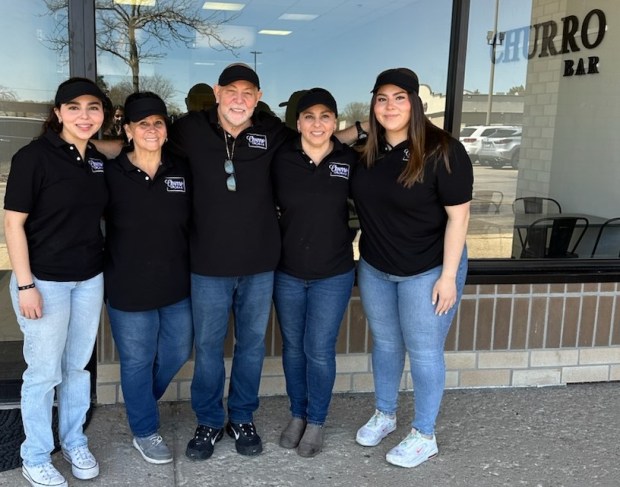 The Churro Bar, a bakery that opened last week on Randall Road in Elgin, is a family affair for owner Ivannia Segura, who is seen here with her parents, Carlos and Sonia Segura, center, daughters Melissa, far left, and daughter Valeria, far right. (Gloria Casas/The Courier-News)