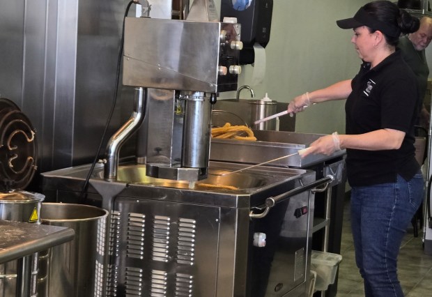 Churros must be deep fried at exactly the right temperature and with the exact right consistency of dough in order to be perfect, according to Ivannia Segura, the owner of the newly opened Churro Bar in Elgin. (Gloria Casas/The Courier-News)
