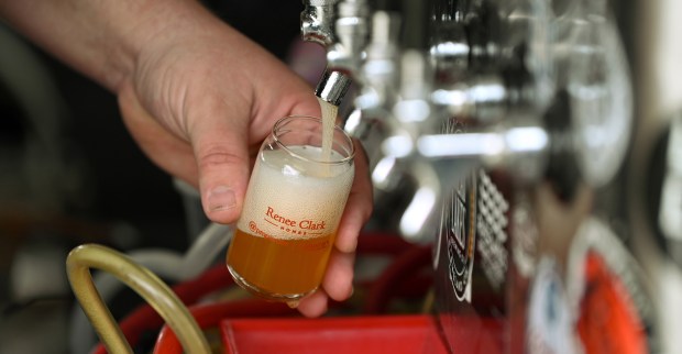 Josh Grubbs, owner of Black Lung Brewing Company of Fox Lake and Round Lake Beach, pours sampler portions at the Craft Beer Festival in Long Grove on April 27, 2024. (Karie Angell Luc/Lake County News-Sun)