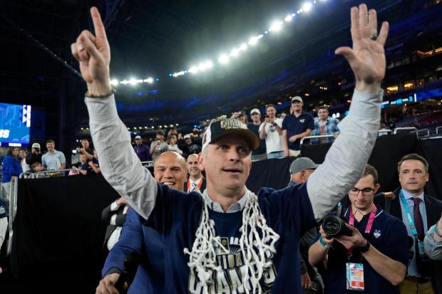 UConn head coach Dan Hurley greets fans after their win against Purdue in the NCAA college Final Four championship basketball game, Monday, April 8, 2024, in Glendale, Ariz. (AP Photo/David J. Phillip)