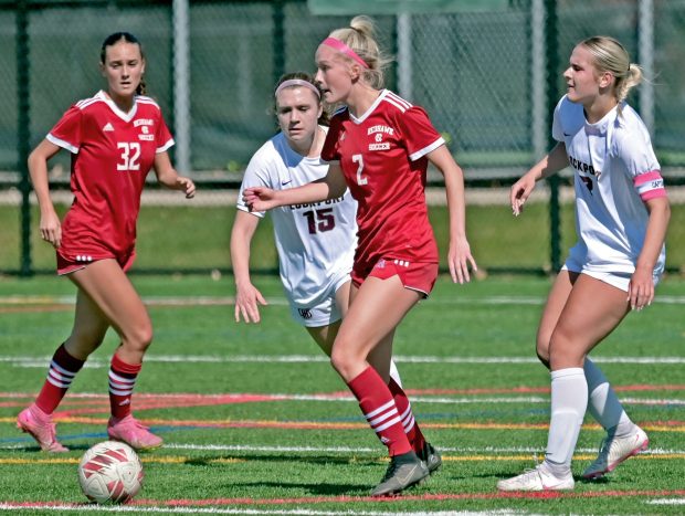 Naperville Central's Chloe Mowry kicks the ball away from Lockport's Natalie Zodrow and Karolina Skubisz. Lockport defeated Naperville Central in girls soccer, 4-0, Saturday, April 13, 2024, in Naperville, Illinois. (Jon Langham/for Naperville Sun)