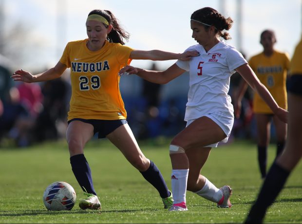 Naperville Central defender Eleanor Kane (5) battles for control of the ball with Neuqua Valley midfielder Grace O'Malley (29) during a game at Neuqua Valley High School in Naperville on Tuesday, April 9, 2024. (Trent Sprague/for the Chicago Tribune)