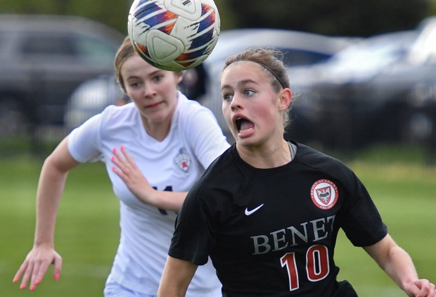 Benet's Annie Fitzgerald (10) races to the ball ahead of Saint Viator's Kalin McCrea during a match on Tuesday, April 23, 2024, in Lisle.(Jon Cunningham/for The Naperville Sun)