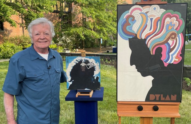 Naperville resident Mark Rice pictured with a copy of the 1967 Bob Dylan's Greatest Hits album and the poster that came with the record's release. Rice brought both to an "Antiques Roadshow" tour stop in Akron, Ohio in June 2023. (Mark Rice)