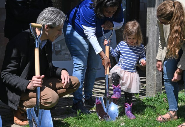 From left, adults Evanston Mayor Daniel Biss, Evanston 2nd ward Councilmember member Krissie Harris and newly elected president of the City of Evanston Parks and Recreation Board, and also secretary of the Evanston Parks Foundation, Ellie Shevick watch Shevick's daughter Rosie Shevick, 4, do a ceremonial shovel dig at the Evanston Ecology Center groundbreaking ceremony on Friday, April 19, 2024 in Evanston at 2024 McCormick Blvd. (Karie Angell Luc/Pioneer Press)