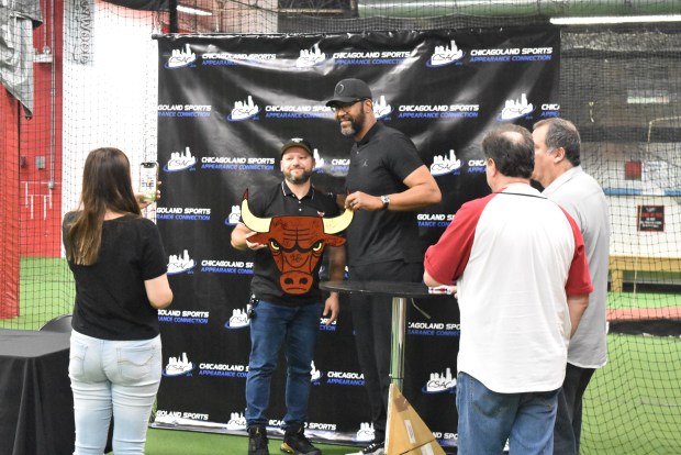 Dickey Simpkins, a former Chicago Bull and NBA champion, poses with fans Sunday. (Jesse Wright)