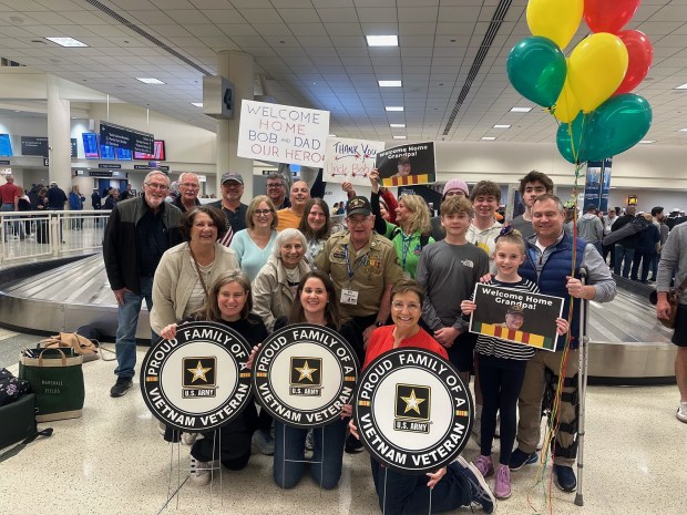 Clarendon Hills resident Bob McDonald (center) was greeted by family members and friends when he returned to Midway Airport on a Chicago Honor Flight (photo by Tracy McDonald)