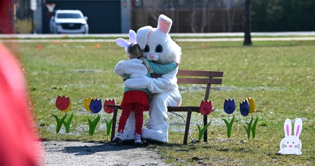 Lilly Geis, 4, of Wicker Park Chicago, goes in for a hug with EB the Bunny. Lilly is visiting extended family in Winnetka who are also in attendance at the annual Egg Hunt in Winnetka at Little Duke Field on March 30, 2024. (Karie Angell Luc/for the Pioneer Press)