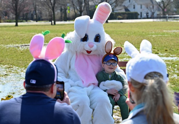 Jack Broderick, 3, of Winnetka poses with EB the Bunny for a photo in the company of family at the annual Egg Hunt in Winnetka at Little Duke Field on March 30, 2024. (Karie Angell Luc/for the Pioneer Press)