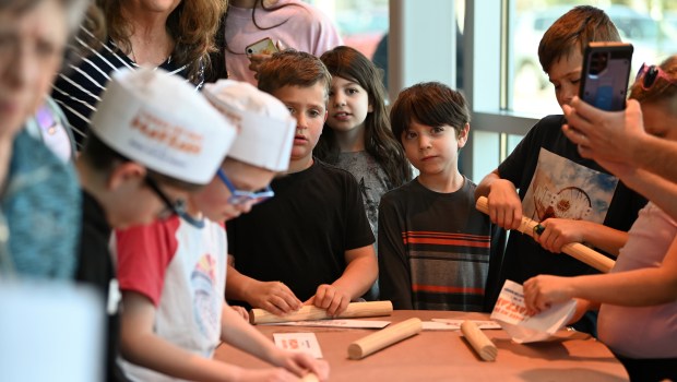 Children participate at the Model Matzah Bakery, a family matzah bake by Chabad of Northbrook at Mariano's in Northbrook on April 15, 2024. (Karie Angell Luc/Pioneer Press)