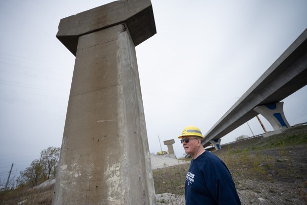 Local labor activist Terry Steagall stands near one of the original, remaining, Cline Avenue Bridge pillars, as he points out features at one of two proposed sites for a memorial to workers who died in the 1982 Cline Avenue Bridge collapse, in East Chicago on Friday, April 26, 2024. (Kyle Telechan/for the Post-Tribune)