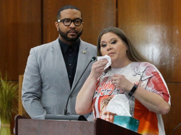 As Gary Mayor Eddie Melton (left) listens, Kandice Cole wipes away tears as she talks about her son who was shot and killed by an unsecured hand gun during the debut of three short gun safety lock videos produced by, and in partnership with, Gary City Councilman and director of the West Side Theatre Guild, Mark Spencer. The videos are both instructional and emotional.The Lake County Prosecutor's Office hosted the press conference at Gary City Hall/Council Chambers on April 22, 2024. (John Smierciak/for the Post-Tribune)