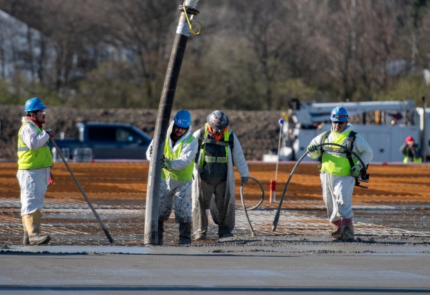 Workers pour the foundation for a cold-storage facility in Hobart on Saturday, April 6, 2024. (Michael Gard/for the Post-Tribune)