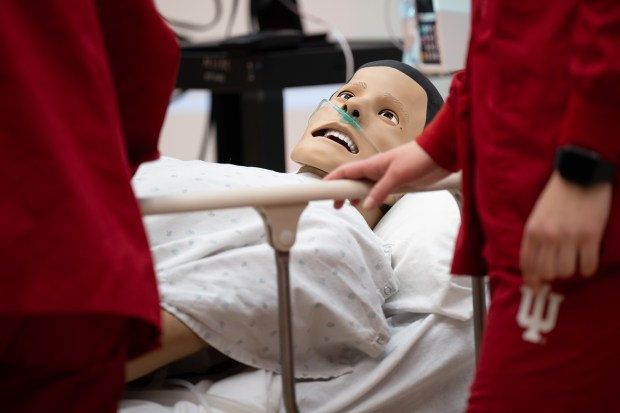 Indiana University School of Nursing students surround a dummy with a simulated illness as they participate in the annual SIM Wars on Thursday, April 25, 2024. (Kyle Telechan/for the Post-Tribune)