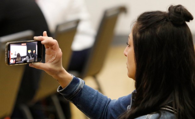 Julianne Verbish records her son, Ashton Verbish of Hanover Central High Schools, as he presents during the Innovate WithIN Region 4 Finals, hosted on the campus of Purdue Northwest along with the Society of Innovators on Friday, April 19, 2024. (John Smierciak/for the Post-Tribune)