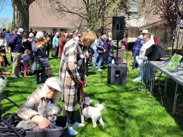 Community members wait for Rev. Mark Wilkins to bless their four-legged companions after a service honoring Snow, Crown Point's albino doe. More than 100 people came out for the April 21 service. (Michelle L. Quinn/Post-Tribune)