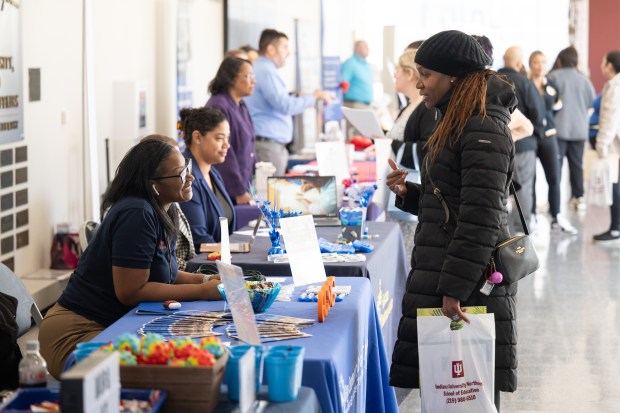 Hobart resident Atinuke Bada, who is seeking a math teaching position, on right, speaks with Gary Community School Corporation benefit specialist Shante Ivy during the Indiana University School of Education's seventh-annual Teacher Recruitment Fair on Friday, April 5, 2024. (Kyle Telechan/for the Post-Tribune)