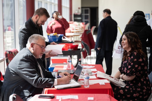 Knox Middle School principal Jim Condon, on left, speaks with prospective teacher Grace Hammons, of St. John, during the Indiana University School of Education's seventh-annual Teacher Recruitment Fair on Friday, April 5, 2024. (Kyle Telechan/for the Post-Tribune)