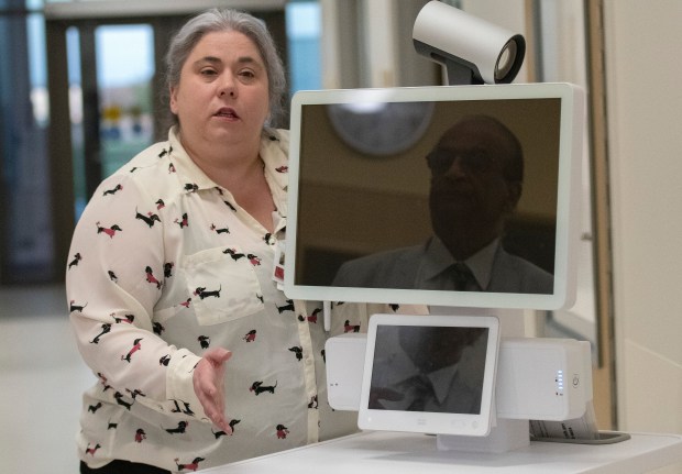 University of Chicago Medicine emergency room nurse Elizabeth Lavendusky shows a telehealth robot at the ribbon cutting for the university's new facility in Crown Point on Thursday, April 25, 2024. (Michael Gard/for the Post-Tribune)