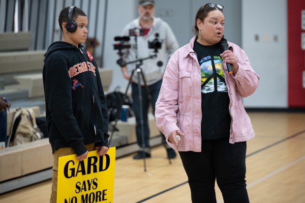 Gary Advocates for Responsible Development member Kimmie Gordon, on right, is accompanied by her 14-year-old son as they address IDEM employees during a public hearing on the Gary Works Air Permit renewal on Thursday, April 25, 2024. (Kyle Telechan/for the Post-Tribune)