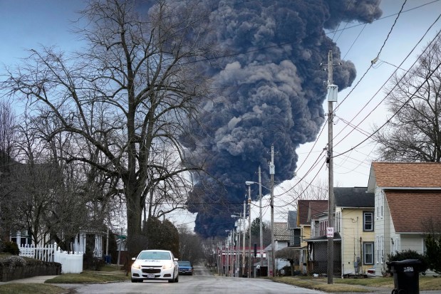 FILE - A black plume rises over East Palestine, Ohio, after a controlled detonation of a portion of the derailed Norfolk Southern trains, Feb. 6, 2023.