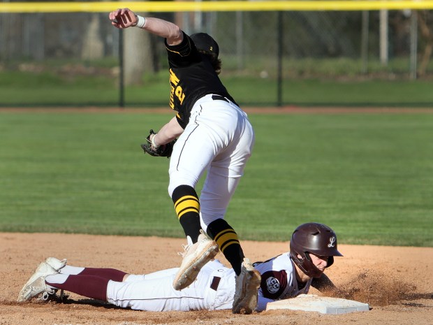 Lockport Adam Kozak slides back to 1st safe as Andrew's Jack Loconte stops the throw during the baseball game in Lockport Monday, April 8, 2024. (James C. Svehla/for the Daily Southtown)