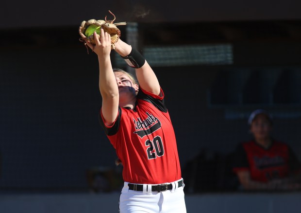 Marist first baseman Layla Peters (20) catches a infield fly ball during a game at Joliet Catholic Academy in Joliet on Monday, April 15, 2024. (Trent Sprague/for Chicago Tribune)