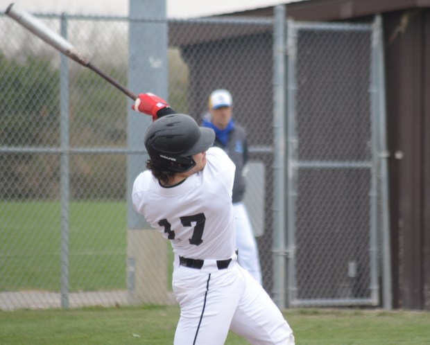 Lincoln-Way Central's Collin Mowry follows through on the first of his two hits against Sandburg during a SouthWest Suburban Conference crossover game in New Lenox on Thursday, April 11, 2024. (Jeff Vorva / Daily Southtown)