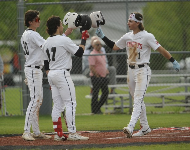 Lincoln-Way Central's Landon Mensik (1) is greeted at home by Liam Arsich (20) and Collin Mowry (17) after hitting his first of two home runs against Stagg during a Southwest Suburban Conference game Monday, April 29, 2024 in New Lenox, IL. (Steve Johnston/Daily Southtown)